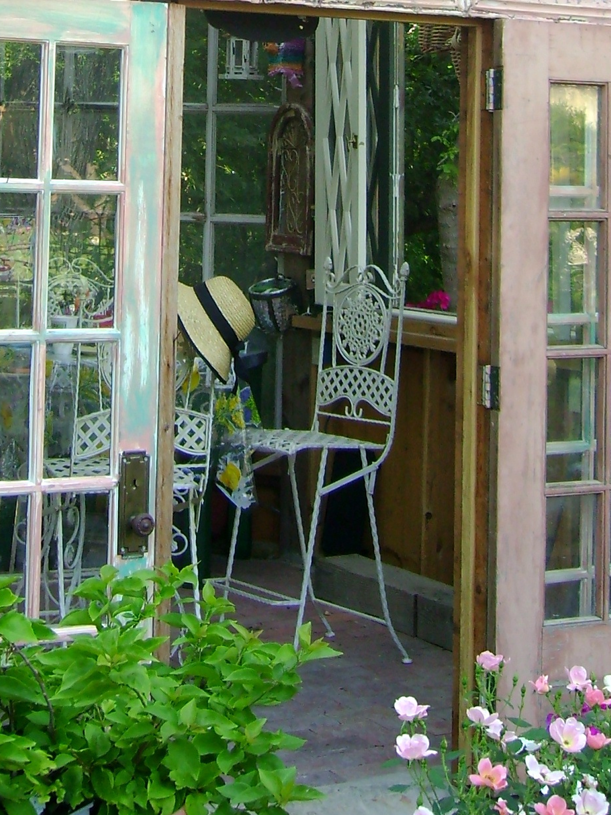 Open door to garden room with chair.