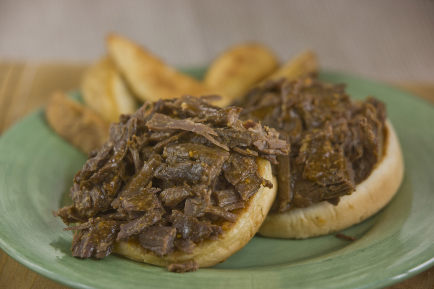 Open-faced roast beef sandwiches with fries.