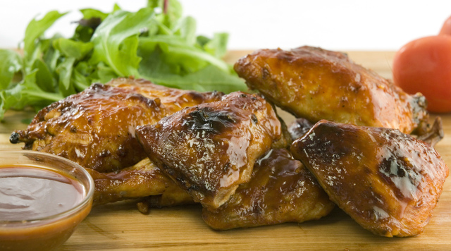 Barbecued chicken with sauce and fresh salad.
