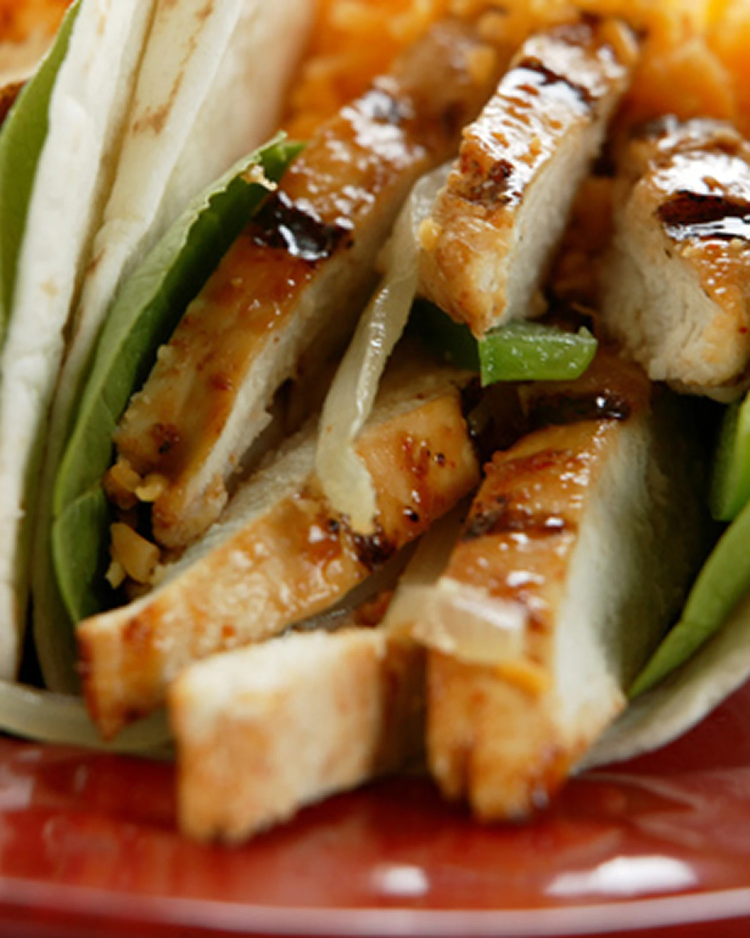 Grilled chicken wraps with fresh vegetables.
