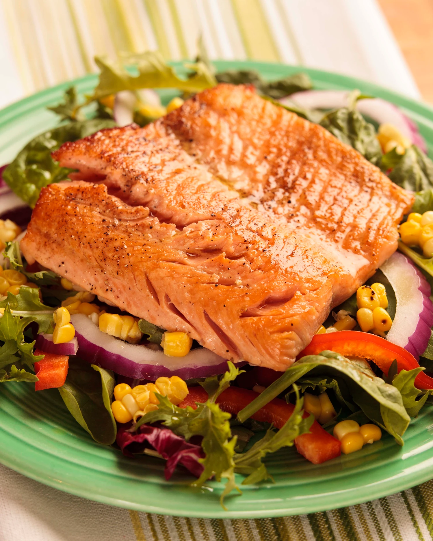 Grilled salmon on salad with vegetables.